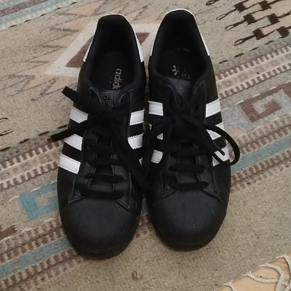 Black and white adidas superstars